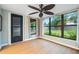 Bright sunroom featuring a black door and large windows with backyard views at 2015 Bayshore Gardens Pkwy, Bradenton, FL 34207