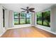 Bright sunroom featuring large windows, ceiling fan, and wood-look floors at 2015 Bayshore Gardens Pkwy, Bradenton, FL 34207