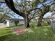 Backyard with beautiful shade trees, outdoor patio, and a fenced in lawn at 2333 22Nd S St, St Petersburg, FL 33712