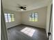 This bedroom has neutral paint, gray flooring, and plenty of natural light coming in from the two windows at 2333 22Nd S St, St Petersburg, FL 33712
