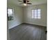 This bedroom has neutral paint, gray flooring, and two windows that provide plenty of natural light at 2333 22Nd S St, St Petersburg, FL 33712