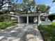 This exterior view of the two-car garage shows that it has two bays, a side door, and a long driveway at 2333 22Nd S St, St Petersburg, FL 33712