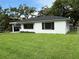 Charming home with a well-maintained lawn, complemented by a white exterior, and black shutters at 2333 22Nd S St, St Petersburg, FL 33712