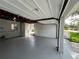 This garage has a painted floor and walls, as well as an entry door to the backyard of the property at 2333 22Nd S St, St Petersburg, FL 33712