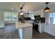 Bright kitchen with island, stainless appliances, black hardware, and modern backsplash at 2333 22Nd S St, St Petersburg, FL 33712