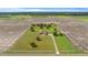 Aerial view of a home on a large lot, surrounded by farmland, showcasing the property's spacious setting at 2350 Virgil Hall Rd, Lithia, FL 33547