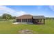 View of the backyard showcasing screened-in porch, pool with patio, and large grassy area in a rural setting at 2350 Virgil Hall Rd, Lithia, FL 33547