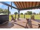 Inviting backyard patio with Adirondack chairs, a fire pit, and peaceful pasture views at 2350 Virgil Hall Rd, Lithia, FL 33547