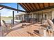 An expansive wood patio with a fire pit and chairs, overlooking the pool and a private pasture at 2350 Virgil Hall Rd, Lithia, FL 33547