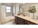 Bright bathroom featuring a bathtub and shower, tile surround, and a granite countertop vanity at 2350 Virgil Hall Rd, Lithia, FL 33547