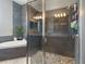 Well-lit bathroom with a soaking tub, rainfall shower and pebbled flooring at 2350 Virgil Hall Rd, Lithia, FL 33547
