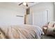 Minimalist bedroom with closet, wicker chair and hardwood floors at 2350 Virgil Hall Rd, Lithia, FL 33547