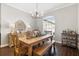 Bright dining room featuring modern light fixtures, large windows, and a wooden dining set at 2350 Virgil Hall Rd, Lithia, FL 33547