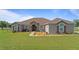 Stunning single-story home with stone accents, well-manicured lawn, and meticulous landscaping at 2350 Virgil Hall Rd, Lithia, FL 33547