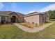 Landscaped front yard with a small seating area and walkway leading to the front door at 2350 Virgil Hall Rd, Lithia, FL 33547
