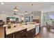 Kitchen view showcasing an island with pendant lighting, a farmhouse sink, and stainless steel dishwasher at 2350 Virgil Hall Rd, Lithia, FL 33547