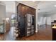 Gourmet kitchen featuring stainless steel refrigerator, dark wood cabinetry, and wood-look flooring at 2350 Virgil Hall Rd, Lithia, FL 33547