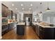 Full kitchen view featuring dual islands, stainless appliances, dark wood cabinetry, and ample counter space at 2350 Virgil Hall Rd, Lithia, FL 33547