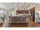 Open kitchen with a large island, stone accents, stainless steel appliances, and ample cabinet space at 2350 Virgil Hall Rd, Lithia, FL 33547