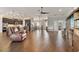 Spacious living area with open layout to the kitchen, tile flooring, and modern furnishings at 2350 Virgil Hall Rd, Lithia, FL 33547