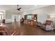 Bright living room boasts wood-look tile floors, a media center with a fireplace, and ample seating at 2350 Virgil Hall Rd, Lithia, FL 33547