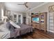 Bright main bedroom with a ceiling fan, natural light, and a large entertainment center at 2350 Virgil Hall Rd, Lithia, FL 33547