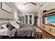 Cozy main bedroom includes a ceiling fan, decorative pillows, and an entertainment center at 2350 Virgil Hall Rd, Lithia, FL 33547