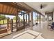 Wide view of a large screened lanai with exposed beam pavilion, overlooking a lush lawn and pool at 2350 Virgil Hall Rd, Lithia, FL 33547