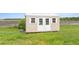 Image of an outdoor shed with double doors and windows, situated on a well-maintained lawn at 2350 Virgil Hall Rd, Lithia, FL 33547