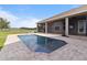 An expansive backyard and private pool deck with views of the house and back screened porch at 2350 Virgil Hall Rd, Lithia, FL 33547