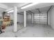 Spacious basement with concrete flooring and a garage door access, perfect for storage or workshop at 2400 Miguel Bay Dr, Terra Ceia, FL 34250