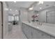 Bright bathroom featuring double vanity, quartz countertops, and ample storage at 2400 Miguel Bay Dr, Terra Ceia, FL 34250