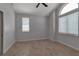 Bright bedroom with wood-look tile floors, a ceiling fan, and a large arched window at 2400 Miguel Bay Dr, Terra Ceia, FL 34250