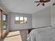 Primary bedroom with gray floors, a ceiling fan, and a sliding glass door to a balcony at 2400 Miguel Bay Dr, Terra Ceia, FL 34250