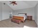 Primary bedroom with vaulted ceiling, ceiling fan, gray floors, and lots of natural light at 2400 Miguel Bay Dr, Terra Ceia, FL 34250