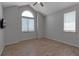 Bright bedroom featuring vaulted ceilings, tiled floors, ceiling fan and large arched window at 2400 Miguel Bay Dr, Terra Ceia, FL 34250