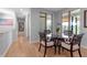 Bright dining area with hardwood floors, a glass table, and views to the exterior at 2400 Miguel Bay Dr, Terra Ceia, FL 34250