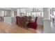 Open-concept dining room with wood floors, elegant furniture, and natural light at 2400 Miguel Bay Dr, Terra Ceia, FL 34250