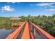 Picturesque waterfront gazebo at the end of a long dock perfect for relaxation and enjoying the serene surroundings at 2400 Miguel Bay Dr, Terra Ceia, FL 34250