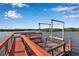 Private dock with boat lift, offering direct access to the water for boating and recreational activities at 2400 Miguel Bay Dr, Terra Ceia, FL 34250