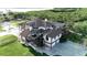 Stunning two-story home featuring a screened-in pool, lush landscaping, and a beautiful outdoor entertainment area near the waterfront at 2400 Miguel Bay Dr, Terra Ceia, FL 34250