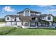 Gorgeous home with an inviting entrance, manicured lawn, and elegant architectural details at 2400 Miguel Bay Dr, Terra Ceia, FL 34250