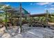 Outdoor gardening area featuring multiple pots and a partially covered structure ideal for plant care and cultivation at 2400 Miguel Bay Dr, Terra Ceia, FL 34250