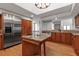 Modern kitchen with stainless appliances, wood cabinetry, and granite countertops at 2400 Miguel Bay Dr, Terra Ceia, FL 34250