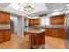 Spacious kitchen featuring a large island, stainless steel appliances, and custom cabinetry at 2400 Miguel Bay Dr, Terra Ceia, FL 34250