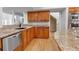 Kitchen featuring granite countertops, custom cabinets, stainless steel appliances, and wood floors at 2400 Miguel Bay Dr, Terra Ceia, FL 34250