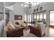 Bright living room featuring high ceilings, hardwood floors, and a decorative chandelier at 2400 Miguel Bay Dr, Terra Ceia, FL 34250