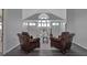 Upper loft with hardwood floors and bright windows looking out to the landscape at 2400 Miguel Bay Dr, Terra Ceia, FL 34250