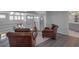Open loft with hardwood floors and bright windows with a decorative railing at 2400 Miguel Bay Dr, Terra Ceia, FL 34250