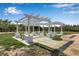Beautifully designed pergola with seating area, ideal for outdoor gatherings and enjoying the lush surroundings at 2400 Miguel Bay Dr, Terra Ceia, FL 34250